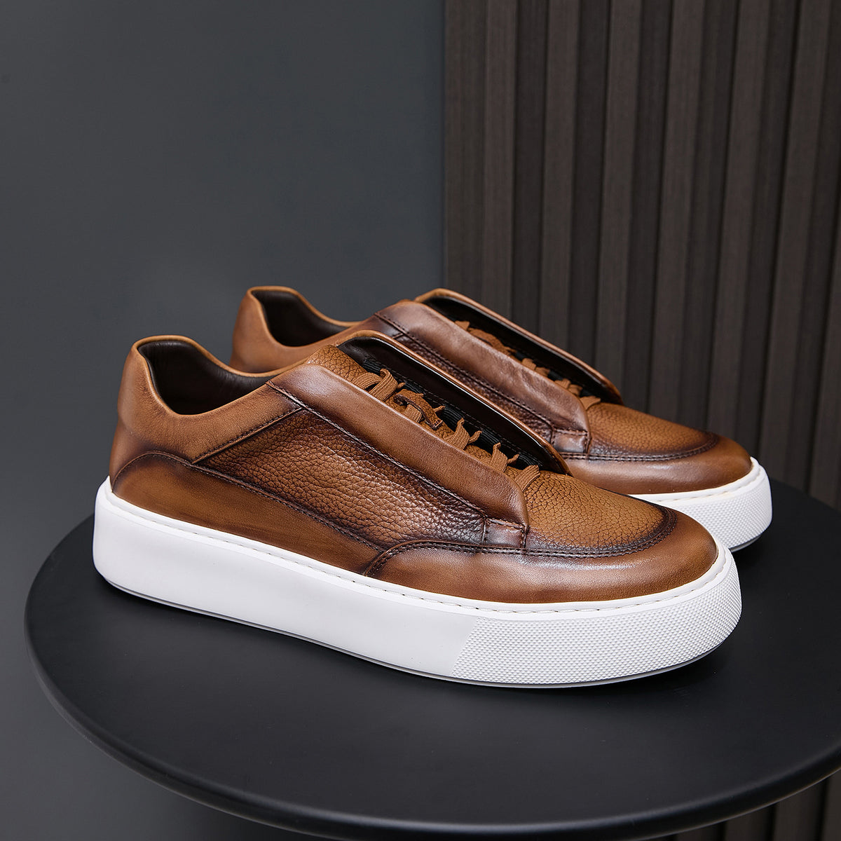 Brown leather lace-up sneakers with low-profile design and white rubber sole