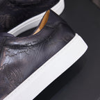 Black leather sneaker heel close-up with white sole edge and tan inner lining