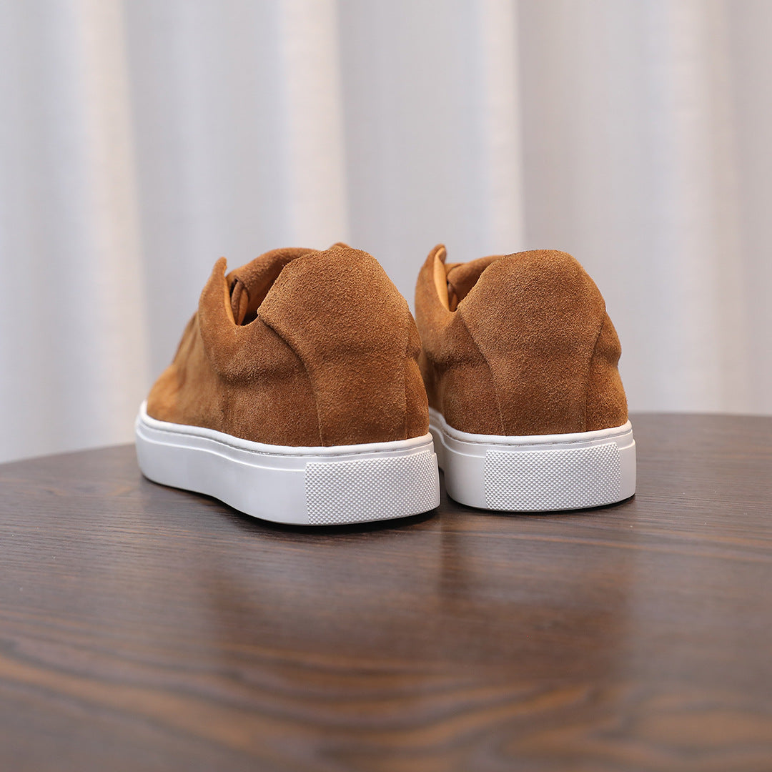 Men's brown suede sneakers, rear view with white rubber sole and heel tab