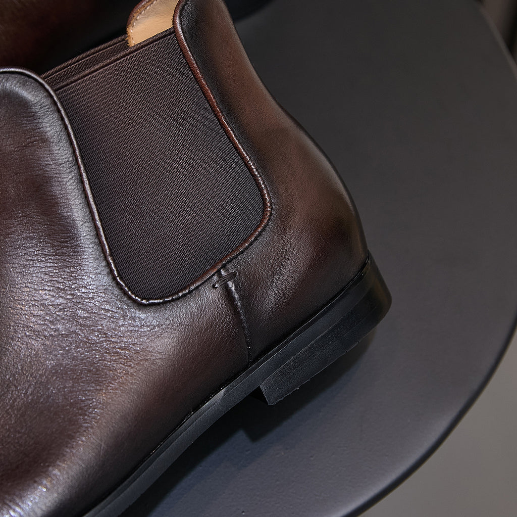 Dark brown suede Chelsea dress boots, close-up of elastic gore and stitched edging
