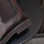 Men's pointed-toe Chelsea dress boots, dark brown heel side with elastic gore and sole trim