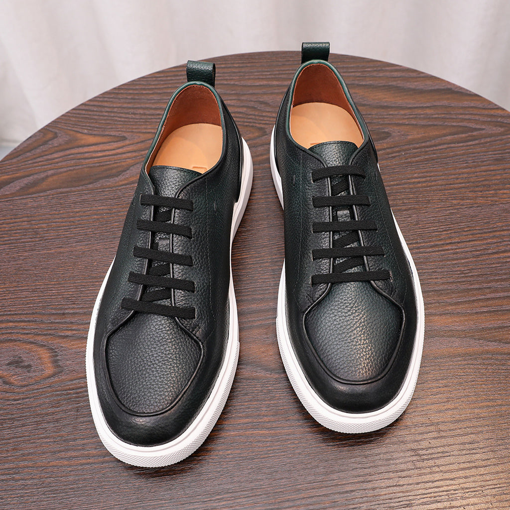 Black genuine leather sneakers pair with lace-up closure, teal lining, and white soles.