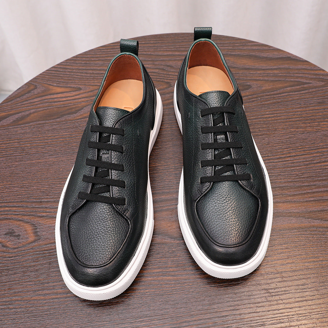 Black genuine leather sneakers pair with lace-up closure, teal lining, and white soles.