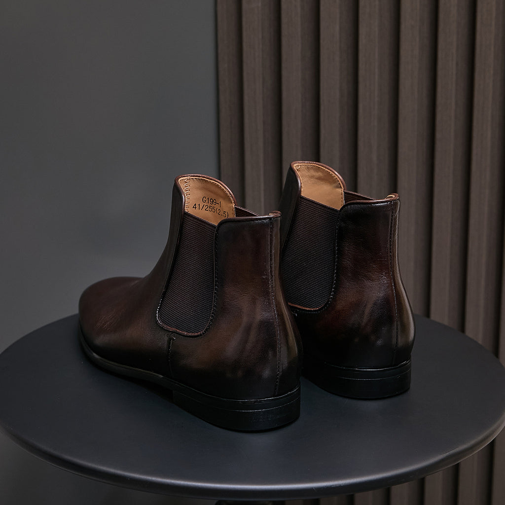Dark brown suede Chelsea dress boots, back view with elastic gores and block heel sole
