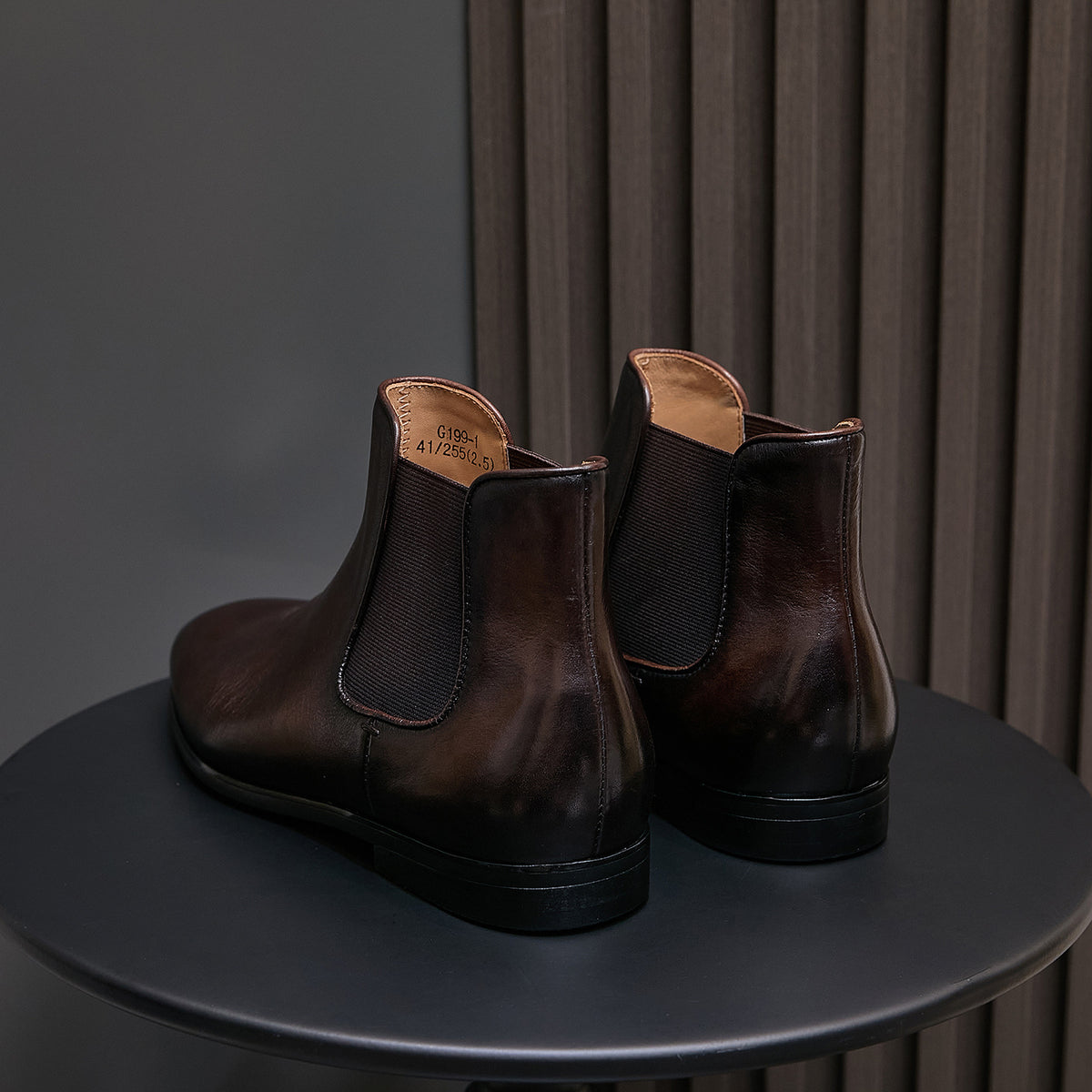 Dark brown suede Chelsea dress boots, back view with elastic gores and block heel sole