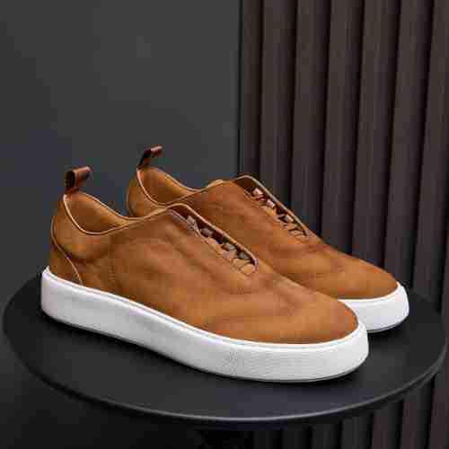 Men's genuine leather sneakers in tan/brown with lace-up front and white rubber sole.