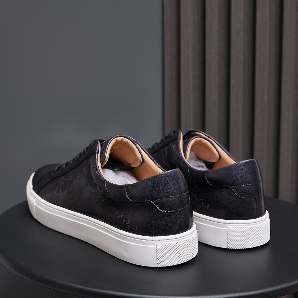 Back view of men’s black leather lace-up sneakers with white rubber heel sole