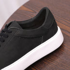 Close-up of black leather sneaker quarter panel and padded collar