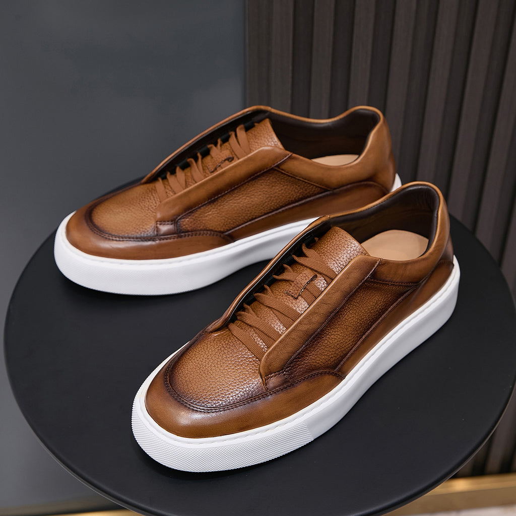 Pair of brown leather sneakers with lace-up front and white platform sole