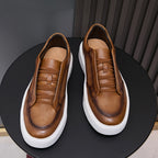 Brown leather sneakers showing interior lining and lace-up tongue