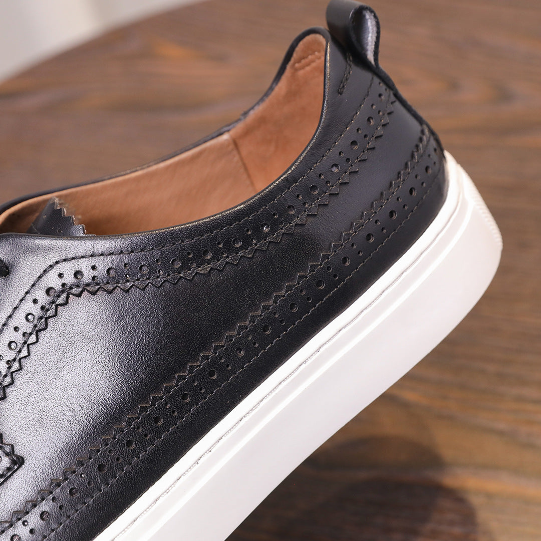 Men’s black leather sneaker with wingtip perforations, lace-up design, and white sole