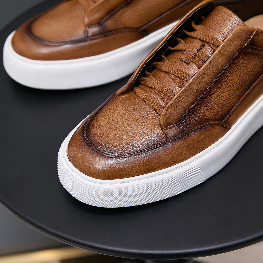Brown leather sneakers with lace-up detail and thick white rubber sole