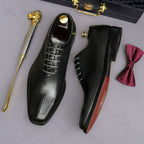 Men's black wingtip brogue oxfords, angled view with visible insole lining