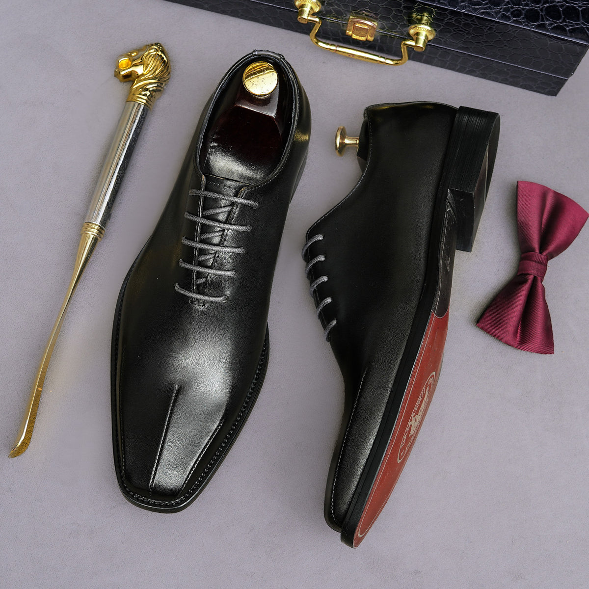 Men's black wingtip brogue oxfords, angled view with visible insole lining