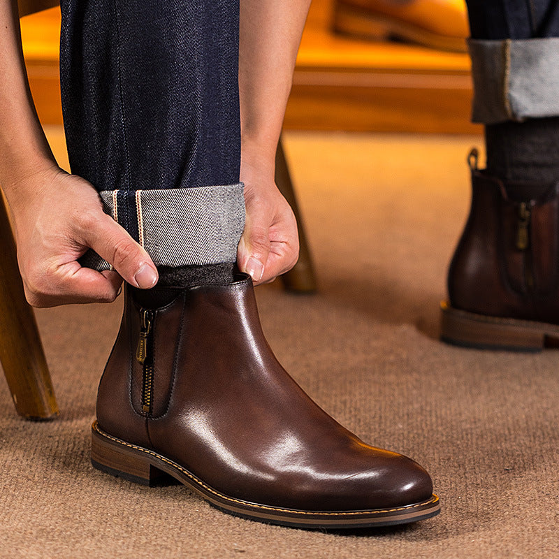 Dark brown leather pointed-toe side-zip dress boot with tan welt; worn with dark pants