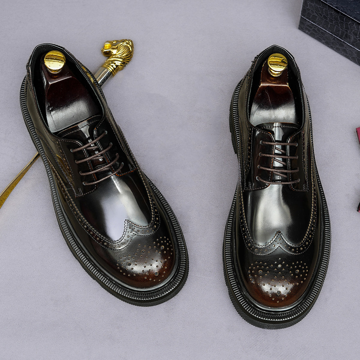 Men's leather pointed-toe derby shoes, lace-up front with brogue detailing and dark finish.