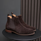 Dark brown suede Chelsea dress boots with elastic side panels and tan welt sole