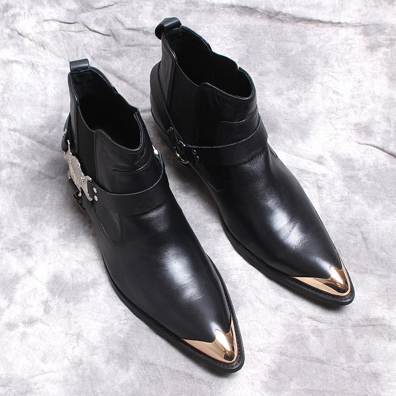 Black leather Chelsea boots with side gore, low heel, and decorative ankle buckle hardware.
