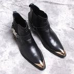 Black leather Chelsea boots with side gore, low heel, and decorative ankle buckle hardware.