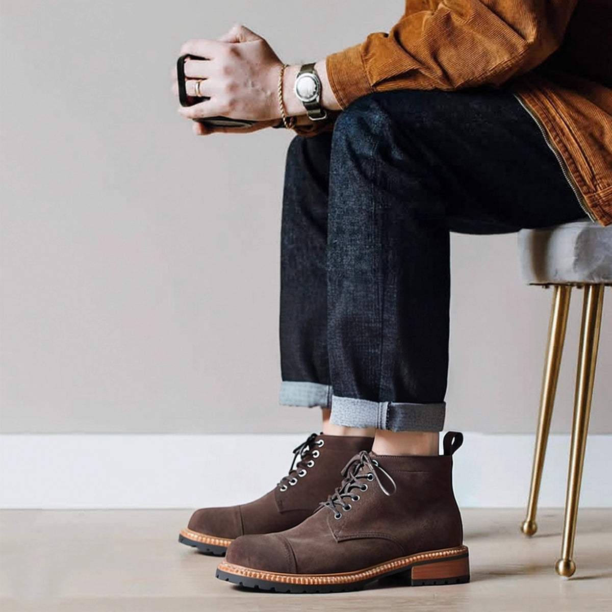 Men's dark brown suede lace-up chukka boots with round toe and tan edge trim