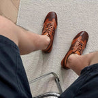 Men's brown leather sneakers with lace-up front and cushioned ankle collar