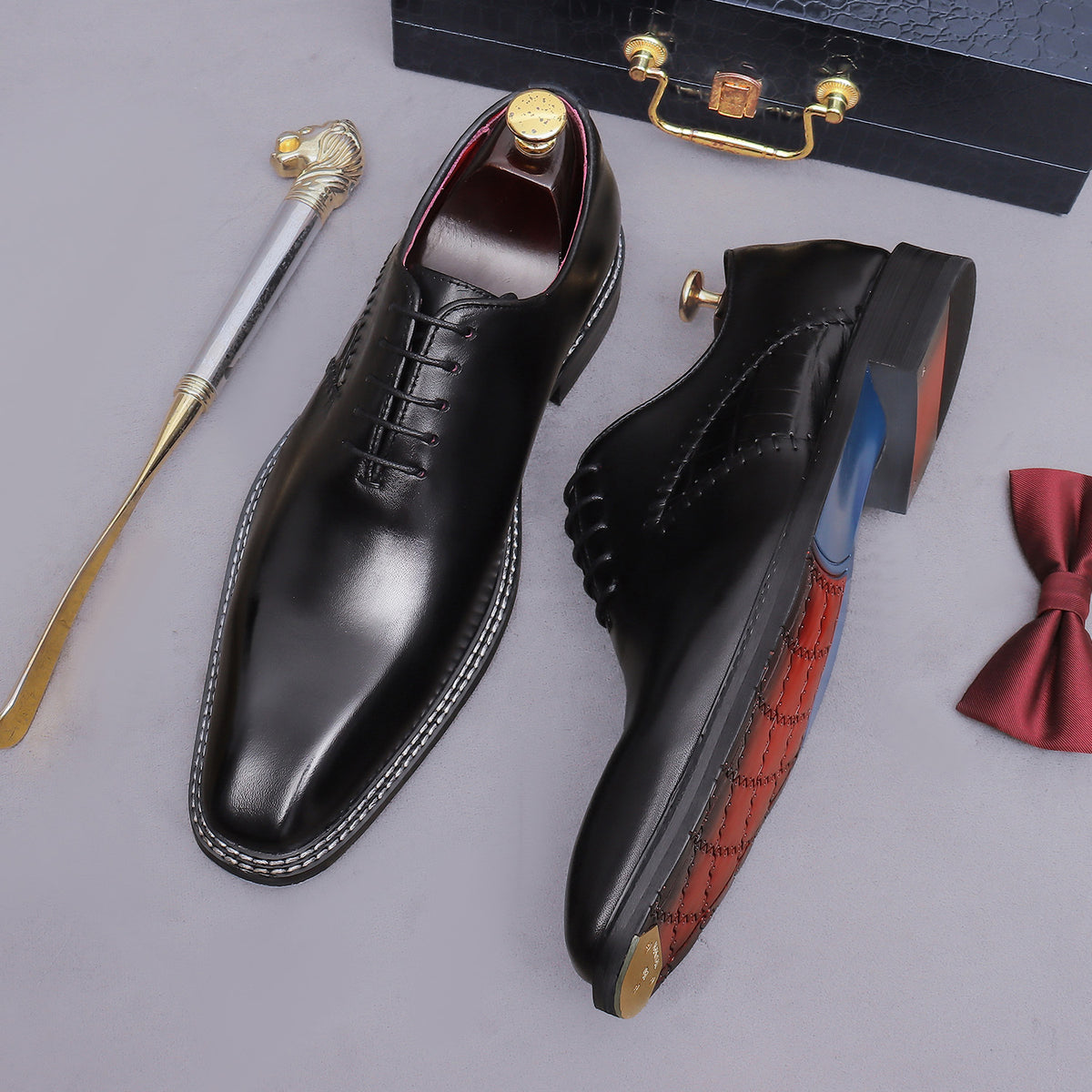 Black wingtip brogue oxford shoes with chunky lug sole, lace-up pair with blue lining