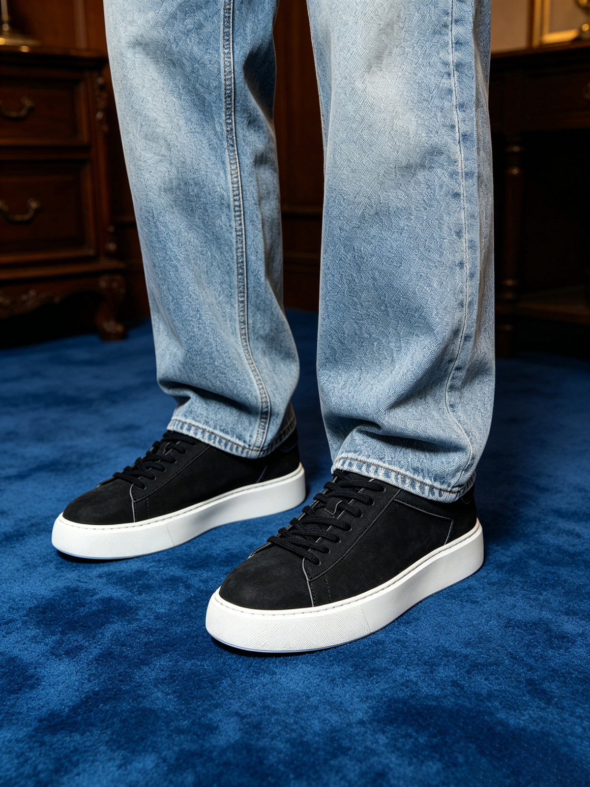 Black leather low-top sneakers with black laces and white rubber sole