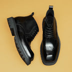 Black leather lace-up ankle boots with side zipper, thick sole, and brogue toe