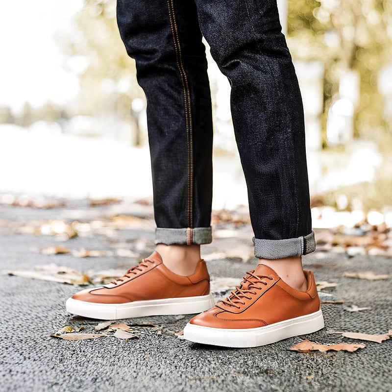 Brown leather sneakers with tan rubber sole and lace-up front