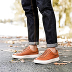 Brown leather sneakers with tan rubber sole and lace-up front
