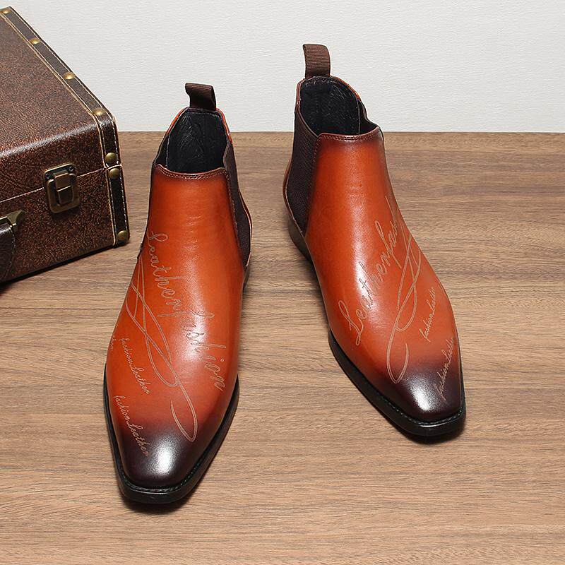 Brown leather Chelsea boots with elastic side panels, pull tabs, and sleek rounded toe