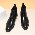 Black leather lace-up Chelsea dress boots with elastic side panels and round toe