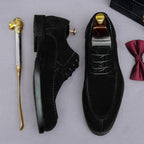 Men's black lace-up Oxford shoes with wingtip brogue detailing and chunky lug sole