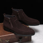 Brown suede side-zip ankle boots on display, stitched toe and thick sole