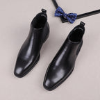 Black leather slip-on Chelsea boots with elastic side gore and low-profile sole