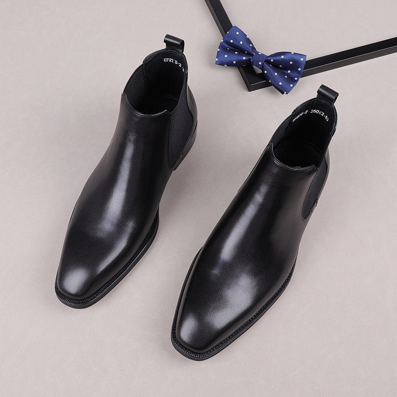 Black leather slip-on Chelsea boots with elastic side gore and low-profile sole