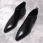 Black leather slip-on Chelsea dress boot pair with side elastic gore