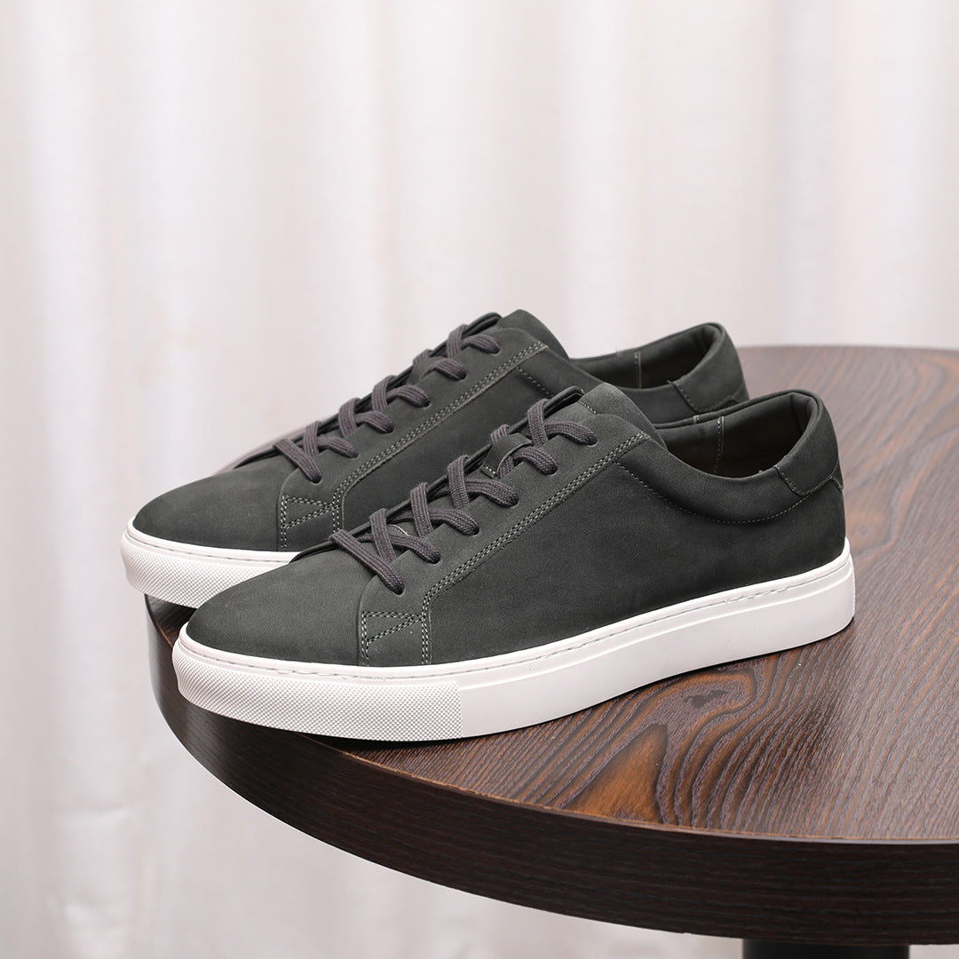 Dark gray suede leather sneakers with lace-up closure and white rubber sole.