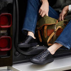 Men's black leather low-top sneakers with lace-up front and white rubber sole