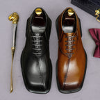 Men's chunky lug-sole wingtip brogue oxfords, black and tan, lace-up pair view.