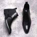 Pair of black leather Chelsea dress boots with elastic side gore and low stacked heels