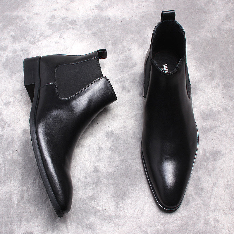 Pair of black leather Chelsea dress boots with elastic side gore and low stacked heels