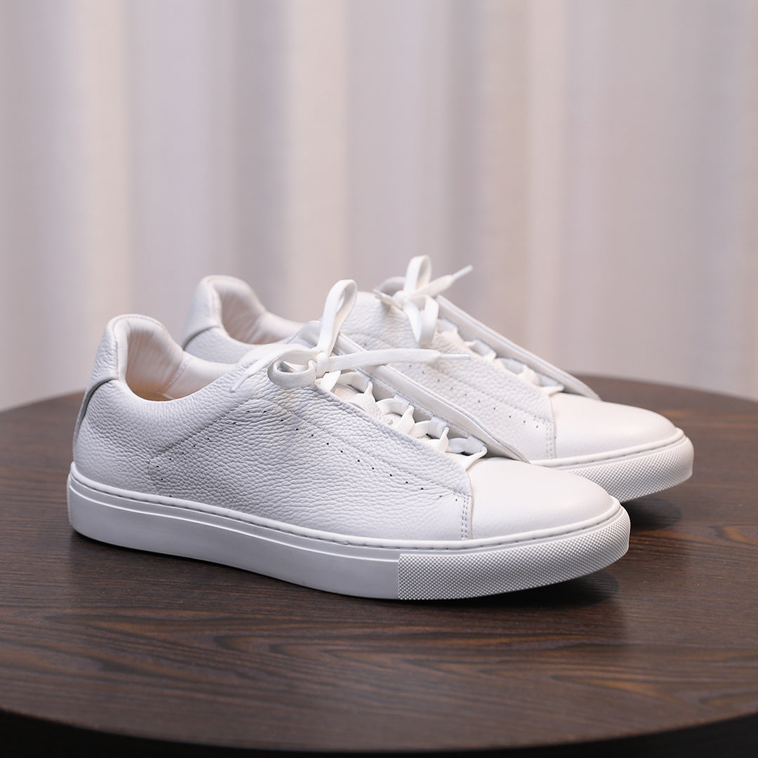 Men's genuine leather sneakers, white pair on display with lace-up front and cushioned collar
