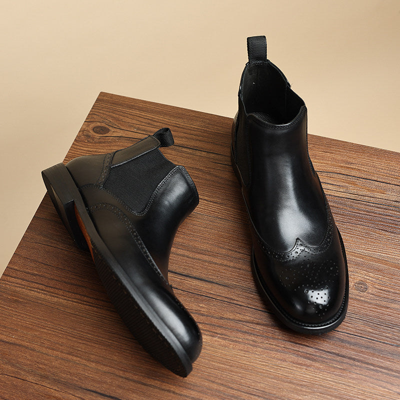 Men's black leather chelsea dress boots, slip-on elastic gore, wingtip-style toe.