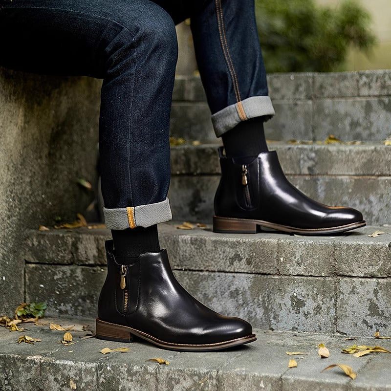 Black leather pointed-toe ankle boots with side zipper and brown sole edge