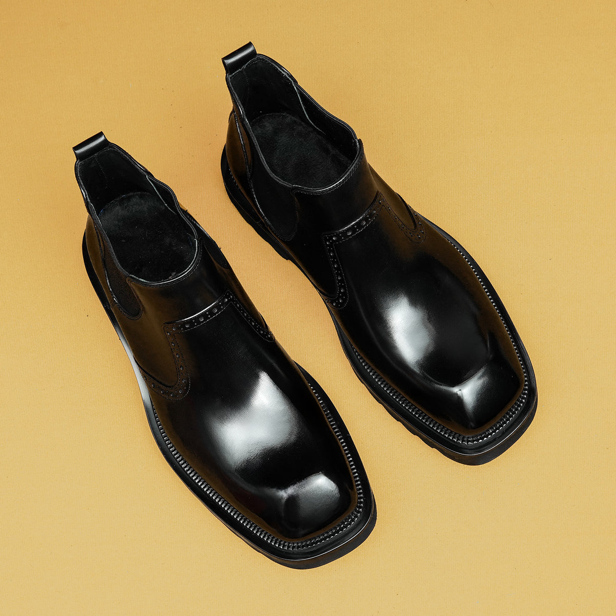 Men's black leather chelsea dress boots with elastic gore, stitched toe detail, lug sole