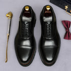 Black lace-up oxford shoes with smooth toe and detailed edge stitching
