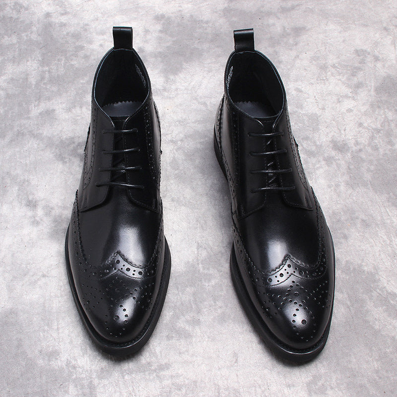 Black lace-up dress boots with wingtip perforations and smooth leather finish