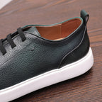 Dark green genuine leather sneaker with lace-up straps and smooth side panel detail.