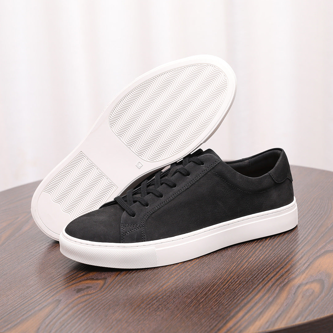 Men's genuine leather sneaker showing outsole tread; dark upper, black laces, white sole
